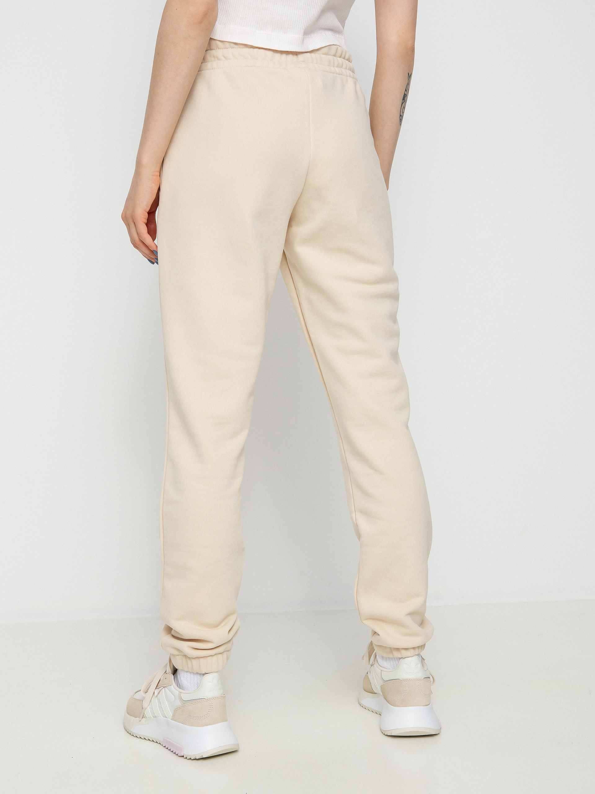 Spodnie New Balance Essentials Celebrate Wmn (beige)